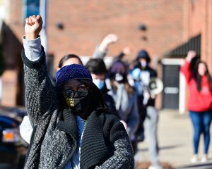 Woman holding up a fist at a rent relief protest in North Carolina earlier this year.