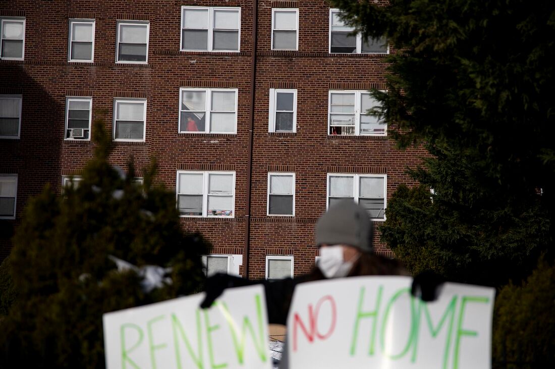 An activist protests evictions in front of a Philadelphia rental building