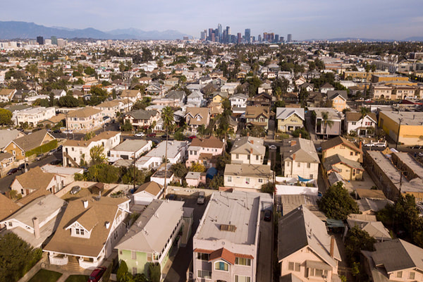 A grid of small bungalows stretches away from the Los Angeles downtown.